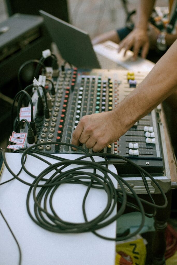 A person is using a mixer to mix music